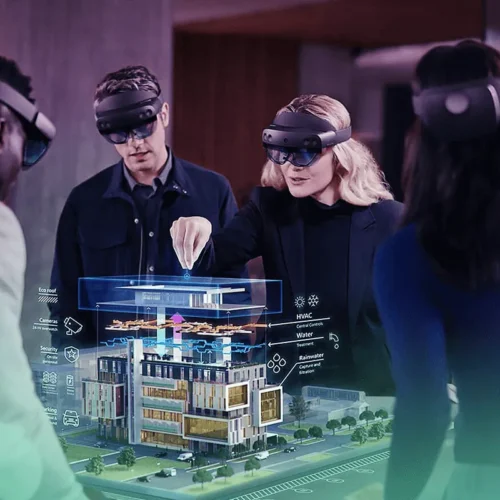 Team using AR headsets to visualize a detailed architectural model in mixed reality, demonstrating advanced 3D Walkthrough and design collaboration technology by Cloudzure.