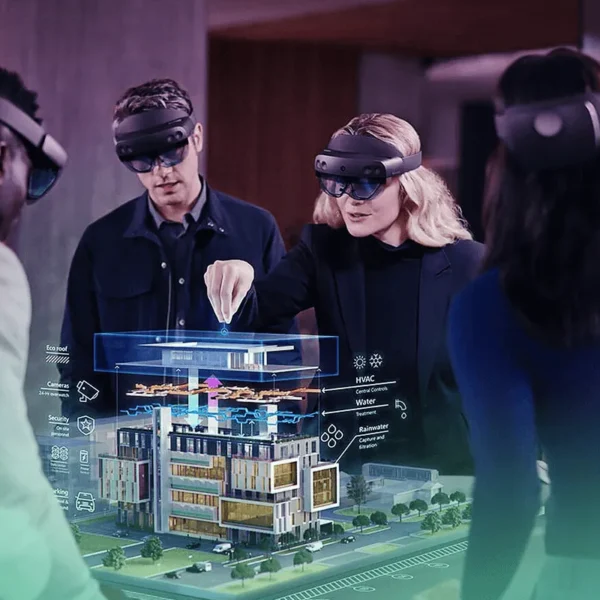 Team using AR headsets to visualize a detailed architectural model in mixed reality, demonstrating advanced 3D Walkthrough and design collaboration technology by Cloudzure.