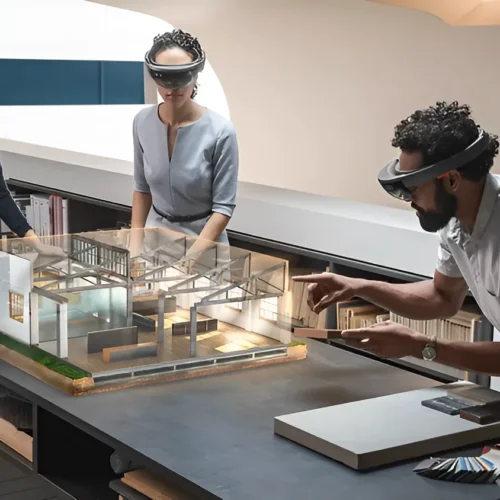 Mixed reality demonstration with users interacting with a digital architectural model using smart glasses in a collaborative workspace.